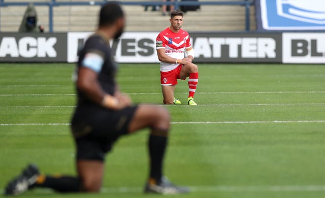 Players take the knee ahead of the match