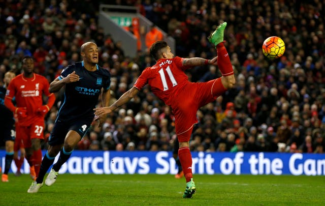 Roberto Firmino attempts to control the ball with a back flick in March 2016 as Vincent Kompany looks on