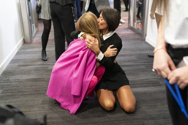 Davina McCall and Amanda Holden share an embrace during the BGC annual charity day at Canary Wharf in London
