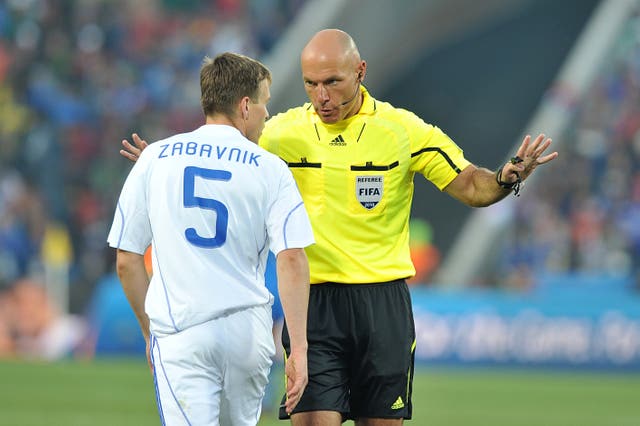 Match referee Howard Webb disciplines Slovakia's Radoslav Zabavnik (left) 