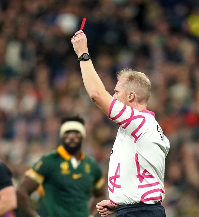 Referee Wayne Barnes shows a red card to New Zealand’s Sam Cane