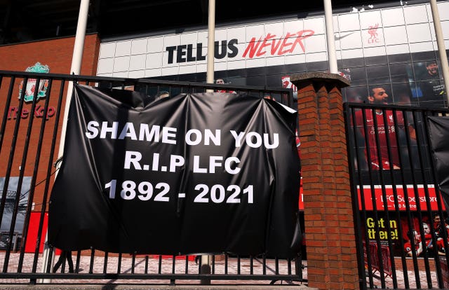 Banners are placed outside of Anfield, home of Liverpool FC by fans to protest against its decision to be included amongst the clubs attempting to form a new European Super League.
