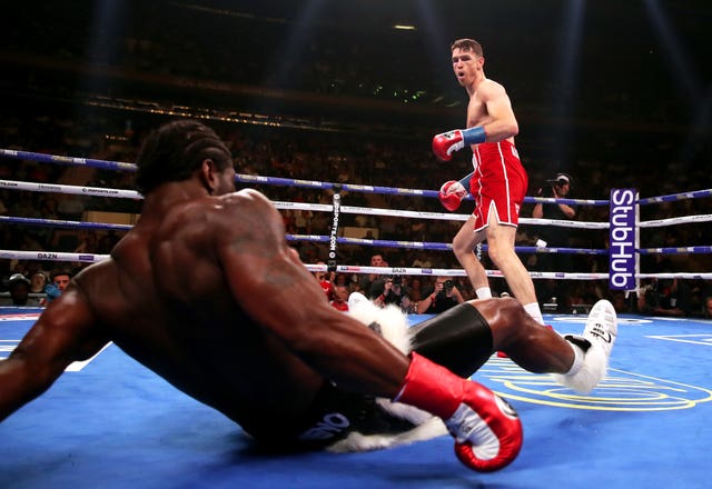 Callum Smith, right, knocks Hassan N'Dam to the canvas