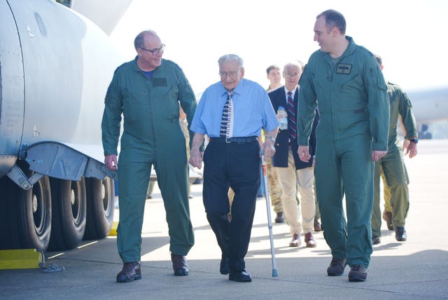 Dennis Bishop accompanied by air crew of a Airbus A400M Atlas military transport aircraft at RAF Brize Norton