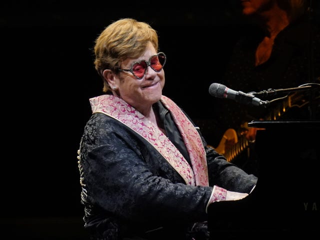 Elton John performs on stage