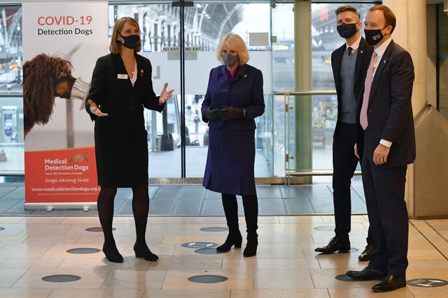 The Duchess of Cornwall (centre) and Health Secretary Matt Hancock (right) watch a demonstration by the charity Medical Detection Dogs. Justin Tallis/PA Wire