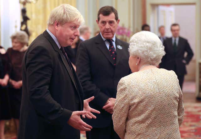 The Queen speaks to Foreign Secretary Boris Johnson, left (Jonathan Brady/PA)