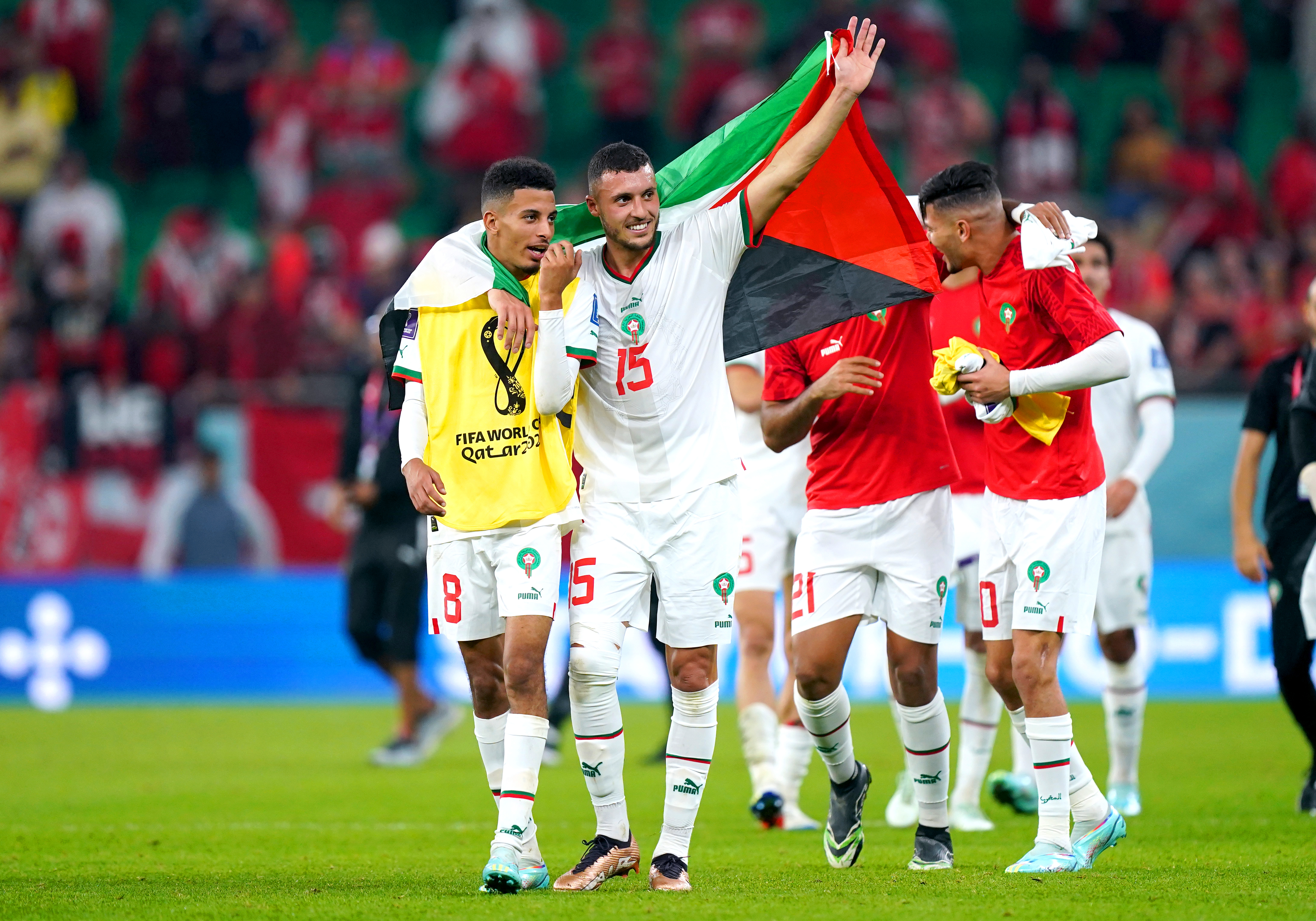 Morocco players celebrate after securing their place in the last 16 as Group F winners