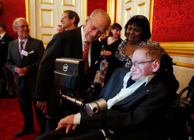 The Duke of Edinburgh greets Professor Stephen Hawking during a reception for Leonard Cheshire Disability in the State Rooms, St James’s Palace, London (PA)