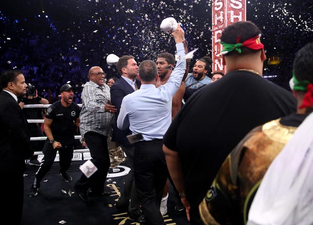 Joshua's promoter Eddie Hearn celebrated wildly with the boxer's team