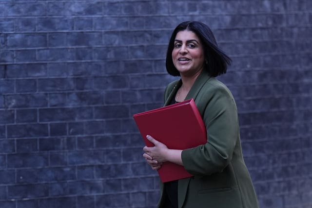 Shabana Mahmood walking along Downing Street carrying a red Government folder