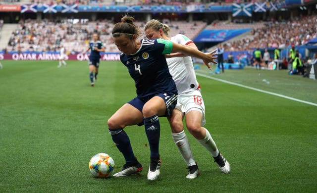 Scotland’s Rachel Corsie, left, holds off England’s Ellen White 