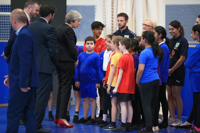 Theresa May talks to children