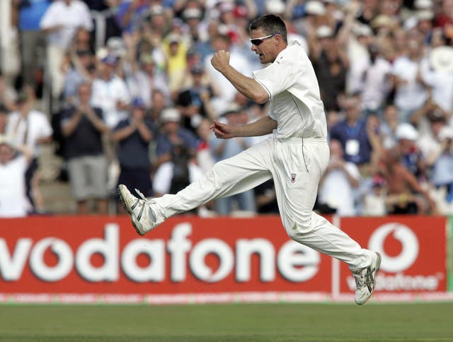 England's Ashley Giles celebrates after clean bowling Australia's Damien Martyn