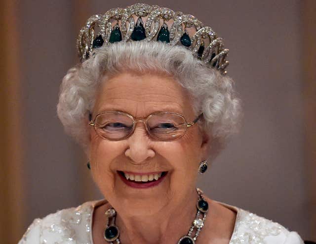 Queen Elizabeth II - in matching earrings - at a CHOGM dinner in Malta (Toby Melville/PA)