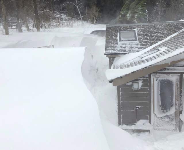 A property near West Linton where officers had to dig an elderly couple and their two dogs out amid a 12ft snow drift around the house (Police Scotland/PA)