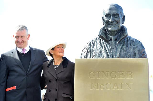 Donald McCain with his mum Beryl at the statue of his father, Ginger, at Aintree