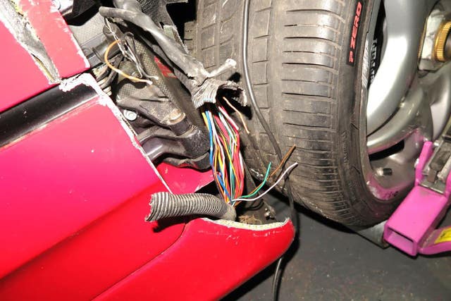 Damage to a high-performance Ferrari F50 shown in court, which Matthew Cobden, of Long Lodge Drive, Walton-on-Thames, lost control of causing it to crash and launch into the air, killing 13-year-old Alexander Worth in North Warnborough, Hampshire, Winchester Crown Court has heard (Crown Prosecution Service/PA)