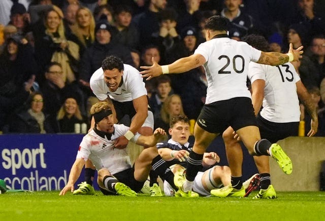 Damian McKenzie (left) celebrates his decisive try for New Zealand
