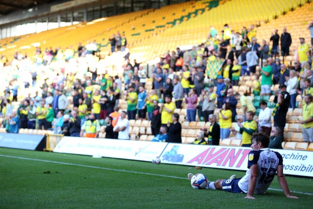 Preston's Ryan Ledson sits on the pitch in front of fans at Carrow Road