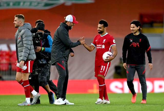 Liverpool manager Jurgen Klopp, centre left, congratulates Mohamed Salah on his hat-trick against Leeds