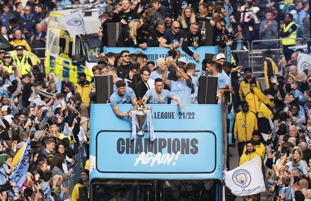 Manchester City players parade through the city centre