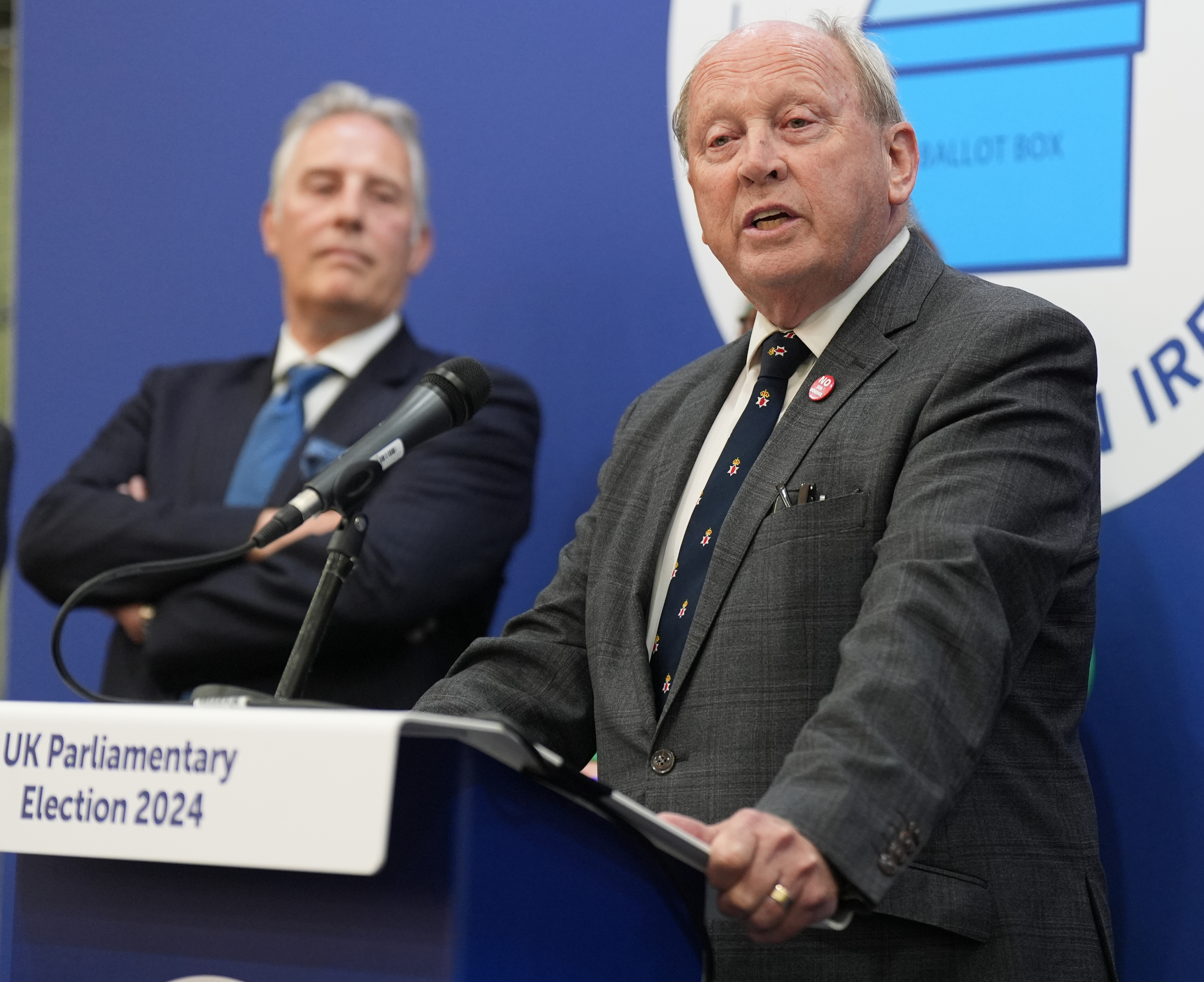 The TUV's Jim Allister stands at a podium after being elected to the North Antrim constituency