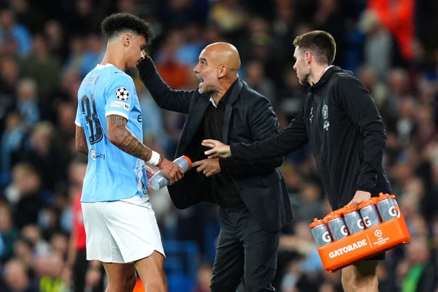 Manchester City manager Pep Guardiola (centre) speaks with Nico O’Reilly