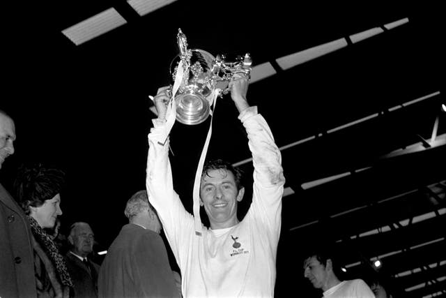 Tottenham Hotspur captain Alan Mullery lifts the League Cup after his team's 2-0 win over Aston Villa