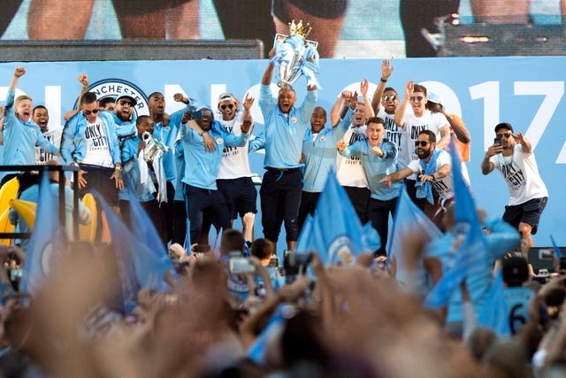 Manchester City players lift the Premier League trophy. (PA)
