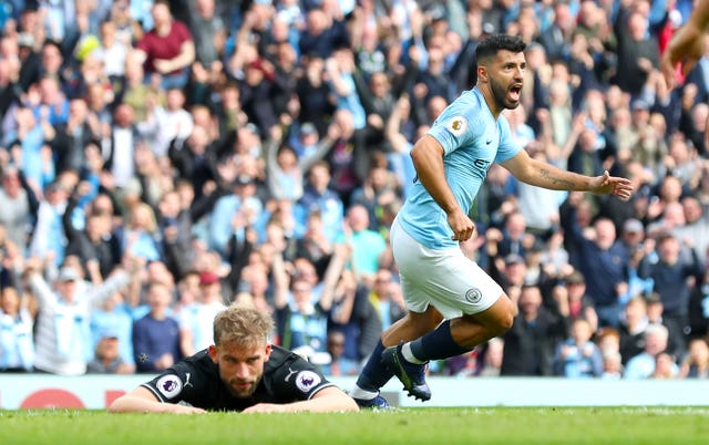 Sergio Aguero, right, celebrates as Charlie Taylor looks dejected during Manchester City's 5-0 victory over Burnley