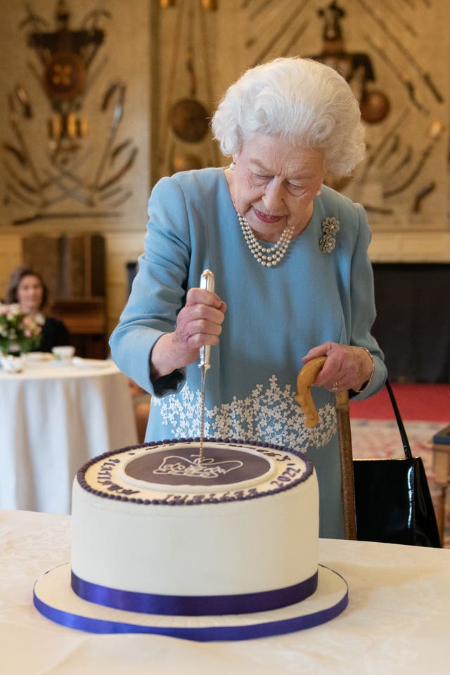 The Queen cuts a cake to celebrate the start of the Platinum Jubilee (Joe Giddens/PA)