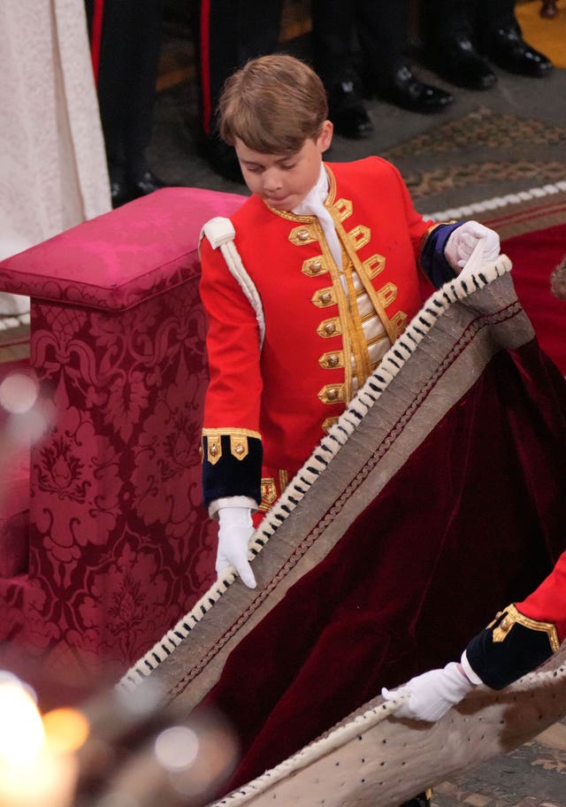 Prince George performing his duties at the coronation ceremony of his grandfather the King