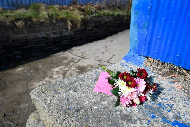 Flowers beside a slipway leading to the River Teifi in Cardigan, Wales, near where the body of two-year-old Kiara Moore was recovered from a car that plunged into the river (Ben Birchall/PA)