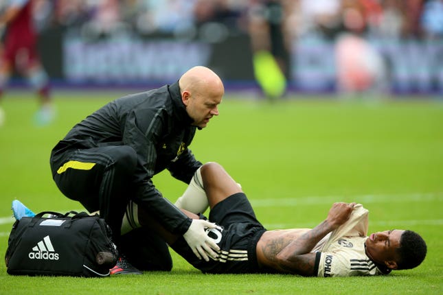 Marcus Rashford receives treatment after picking up an injury