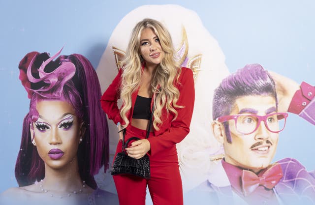 Woman stood in red suit with crop top