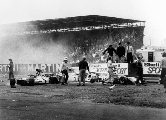 Fire marshals put out fires following a first-lap crash in 1973. The incident resulted in the race being stopped, the first time that had happened in Britain. South African driver Jody Scheckter spun his McLaren-Cosworth M23 and bounced off the pit wall before numerous cars ploughed into him