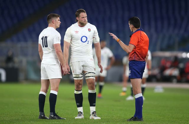 Jonny Hill, centre, is spoken to by referee Pascal Gauzere, right