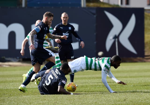 Celtic's Odsonne Edouard is tackled by Dundee's Genseric Kusunga