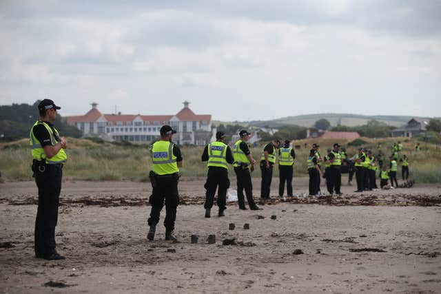 Police formed a protective cordon on the sands