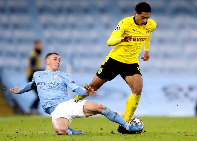 Jude Bellingham, right, takes on England team-mate Phil Foden