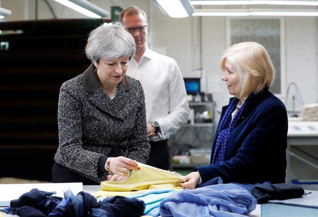 Mrs May visits textile producers Alex Begg in Ayrshire, while on a tour of the four nations of the UK (Russell Cheyne/PA)