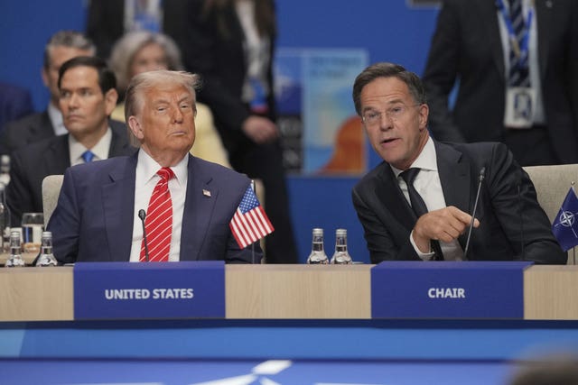 Donald Trump, left, listens while Mark Rutte speaks