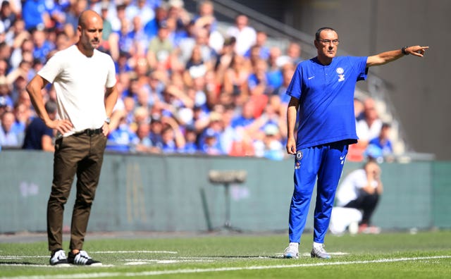 Manchester City manager Pep Guardiola (left) and Chelsea boss Maurizio Sarri look on from the Wembley touchline