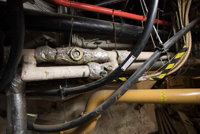 Gas pipes and a mass of cables in the underbelly of the Palace of Westminster