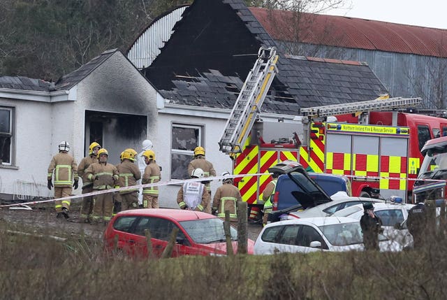Forensic and fire officers at a house (Brian Lawless/PA)