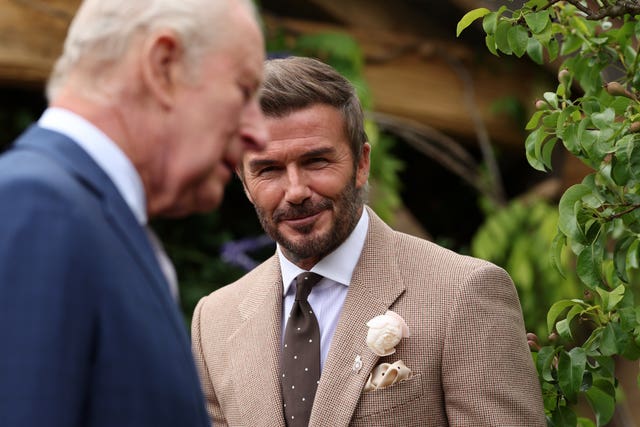 Sir David Beckham smiles as King Charles III (left) visits the RHS Chelsea Flower Show