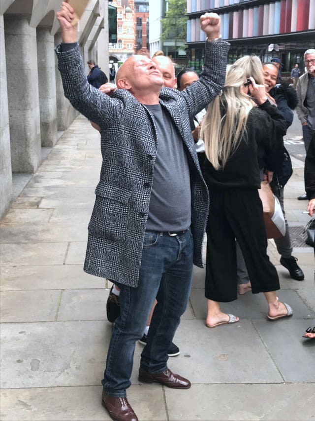 Phillip Huggins celebrates outside the Old Bailey