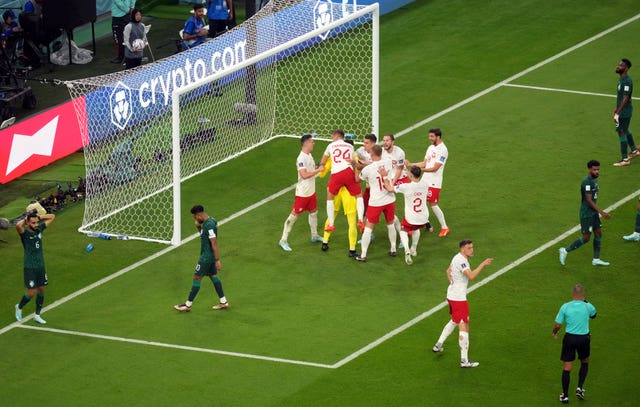 Poland's players mob Szczesny after his double penalty save