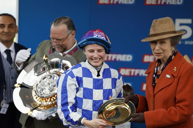 Saffie Osborne is presented with the St Leger trophy by the Princess Royal